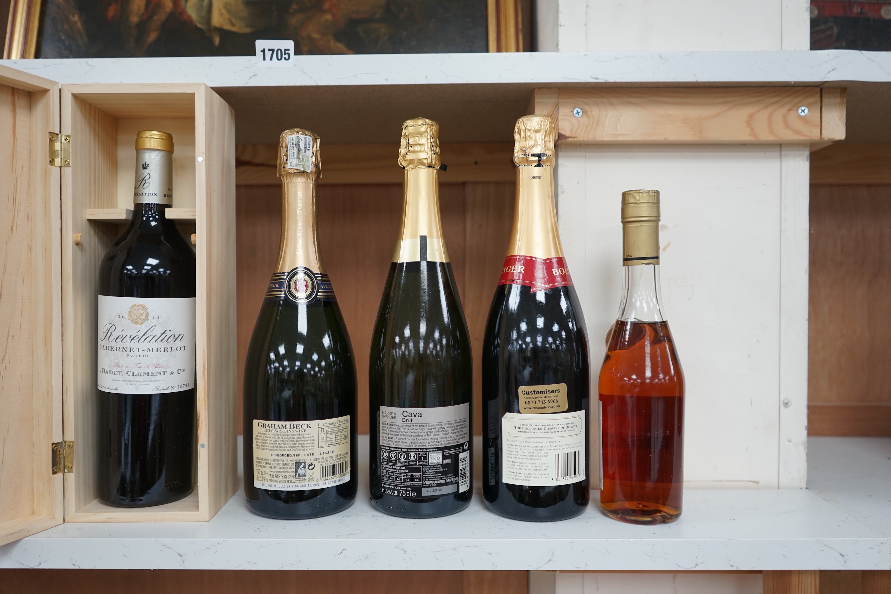 Five bottles; a Graham Beck Brut, a Heretat El Padruell Cava, a Bollinger champagne, a half bottle of Fortnum and Mason Cognac and a wooden bottle of Bevelation 2014 Merlot (5). Condition - good.